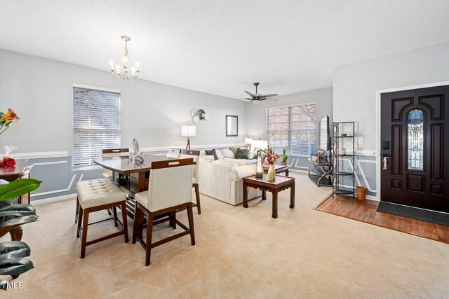 104 Full Moon Ct, Garner, NC 27529 - dining room featuring a chandelier, light carpet, and a ceiling fan