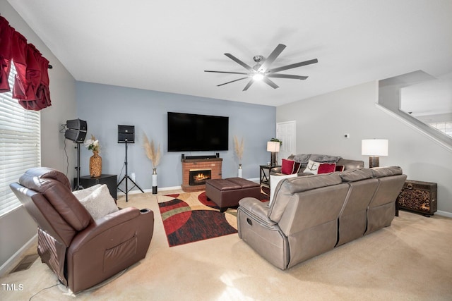 104 Full Moon Ct, Garner, NC 27529 - living area with light colored carpet, a ceiling fan, a brick fireplace, baseboards, and healthy amount of natural light