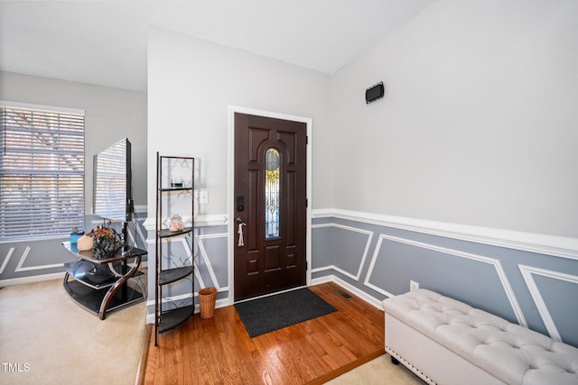 104 Full Moon Ct, Garner, NC 27529 - entryway with wood finished floors, a wainscoted wall, lofted ceiling, and baseboards