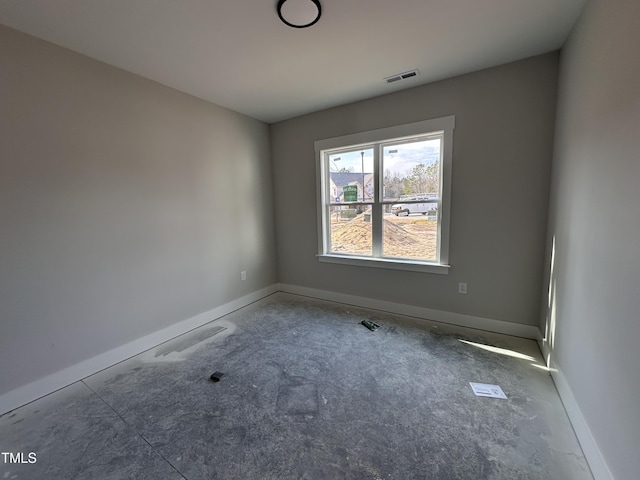 empty room with baseboards and visible vents