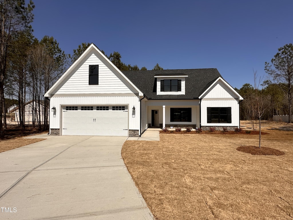 103 Roma Gora Ct, Princeton, NC 27569 - modern farmhouse style home featuring driveway, a shingled roof, and an attached garage