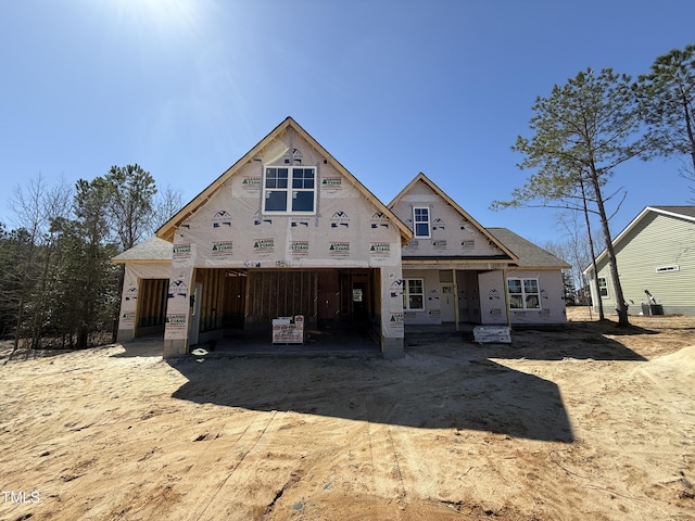 property under construction with covered porch and driveway