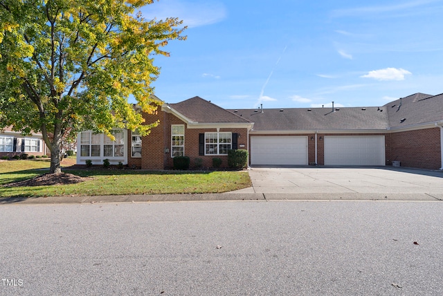 ranch-style house featuring a front yard and a garage