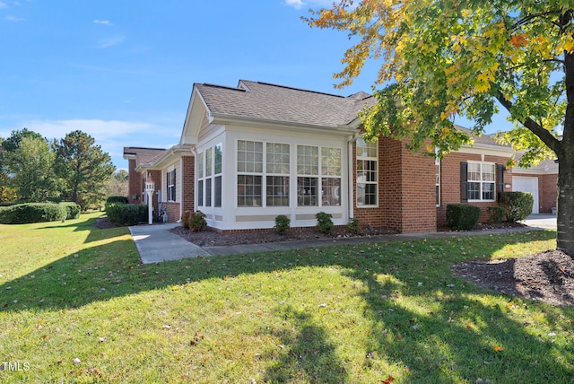 view of front of house with a front yard and a sunroom