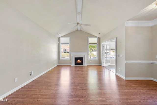 unfurnished living room featuring hardwood / wood-style floors, lofted ceiling with beams, ceiling fan, and a premium fireplace