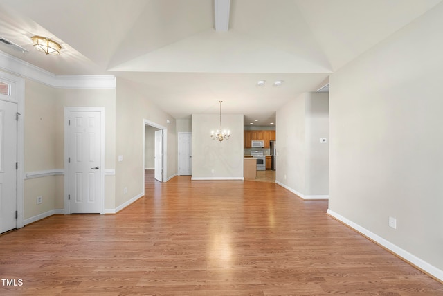 unfurnished living room featuring light hardwood / wood-style flooring, lofted ceiling with beams, and a notable chandelier