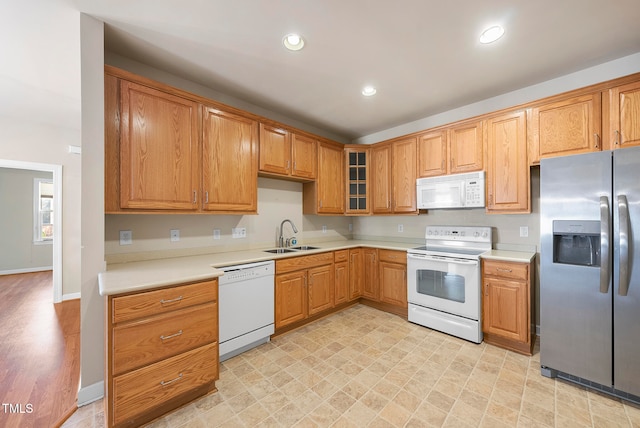 kitchen featuring white appliances and sink