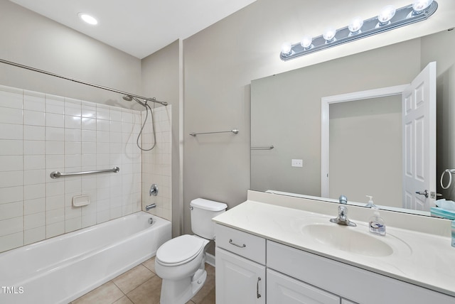 full bathroom featuring toilet, vanity, tiled shower / bath combo, and tile patterned floors