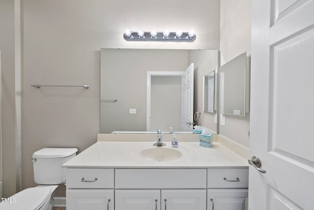 bathroom featuring vanity and toilet