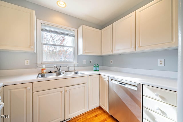 kitchen featuring dishwasher, light hardwood / wood-style floors, and sink