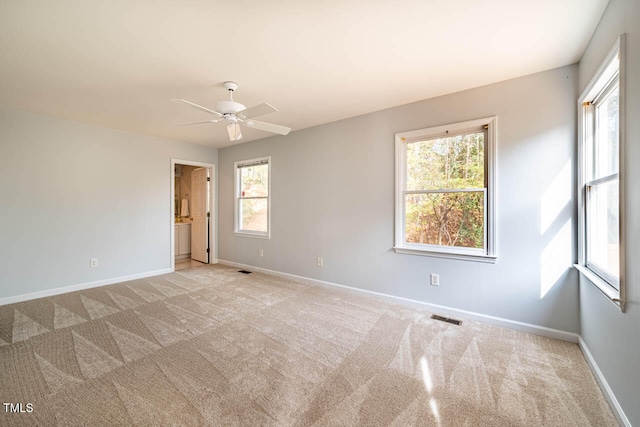 carpeted spare room with ceiling fan