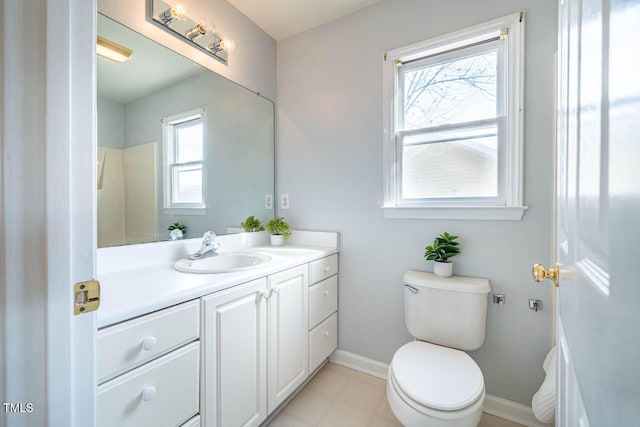 bathroom with a wealth of natural light, vanity, and toilet