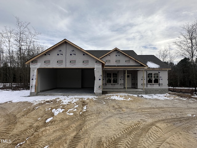 unfinished property with a porch and a garage