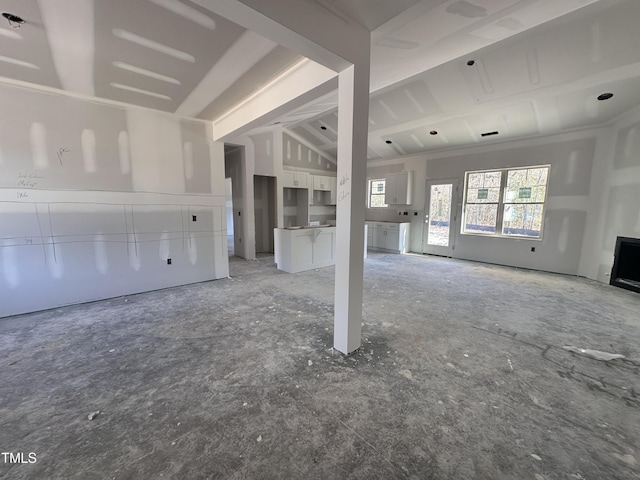 unfurnished living room featuring lofted ceiling