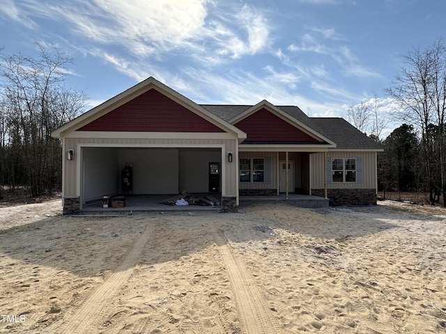 craftsman-style house with board and batten siding, covered porch, and an attached garage