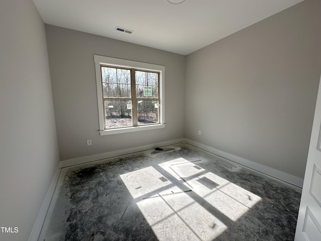 empty room featuring baseboards and visible vents