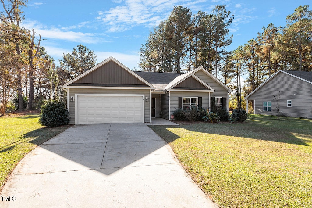 view of front of property with a garage and a front lawn