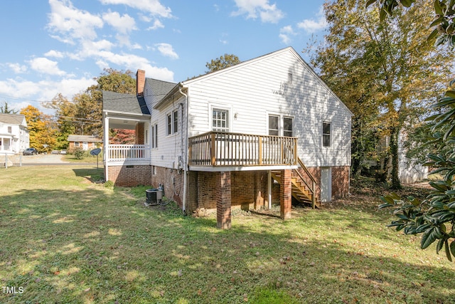 rear view of house with central AC, a yard, and a deck