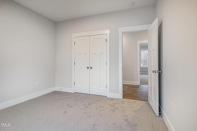 unfurnished bedroom featuring a closet and carpet flooring