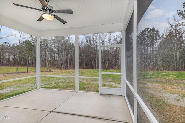 unfurnished sunroom featuring ceiling fan