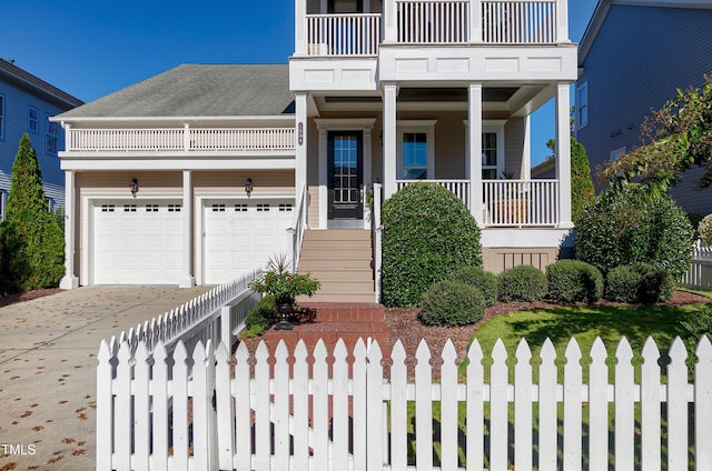 view of front of house featuring a garage and a balcony