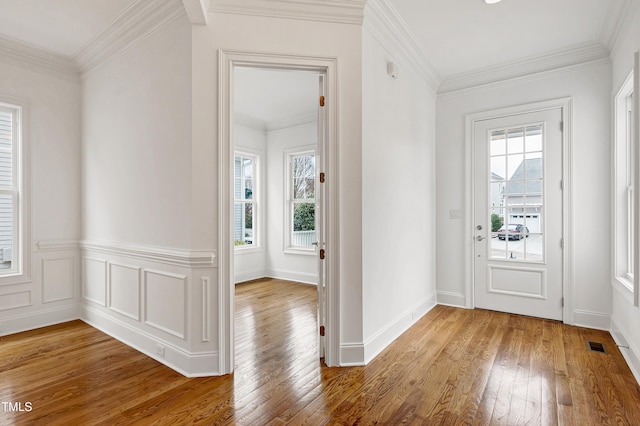 foyer featuring hardwood / wood-style flooring and ornamental molding