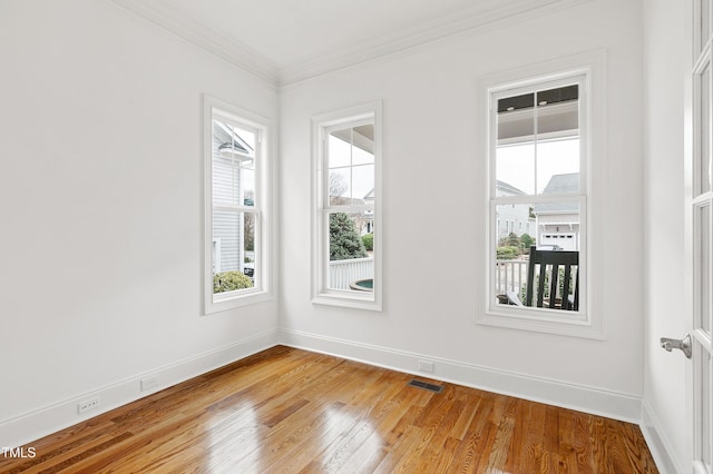 unfurnished room with crown molding and wood-type flooring