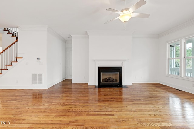 unfurnished living room with ornamental molding, ceiling fan, and light wood-type flooring