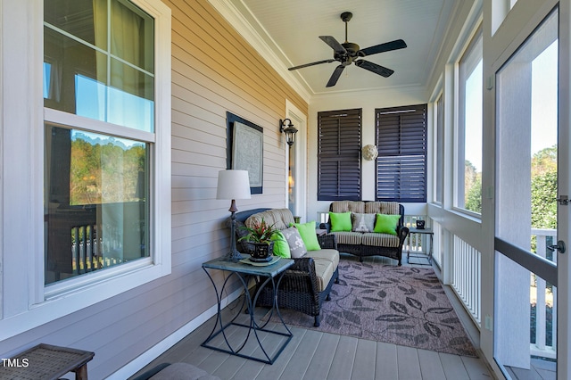 sunroom featuring ceiling fan