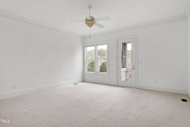 empty room featuring light carpet, crown molding, and ceiling fan