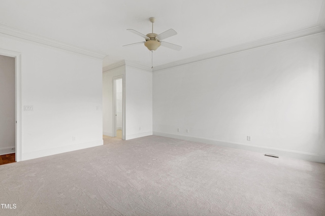 unfurnished room with crown molding, carpet floors, and ceiling fan