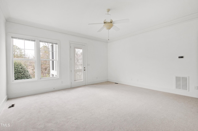 carpeted spare room featuring ornamental molding and ceiling fan