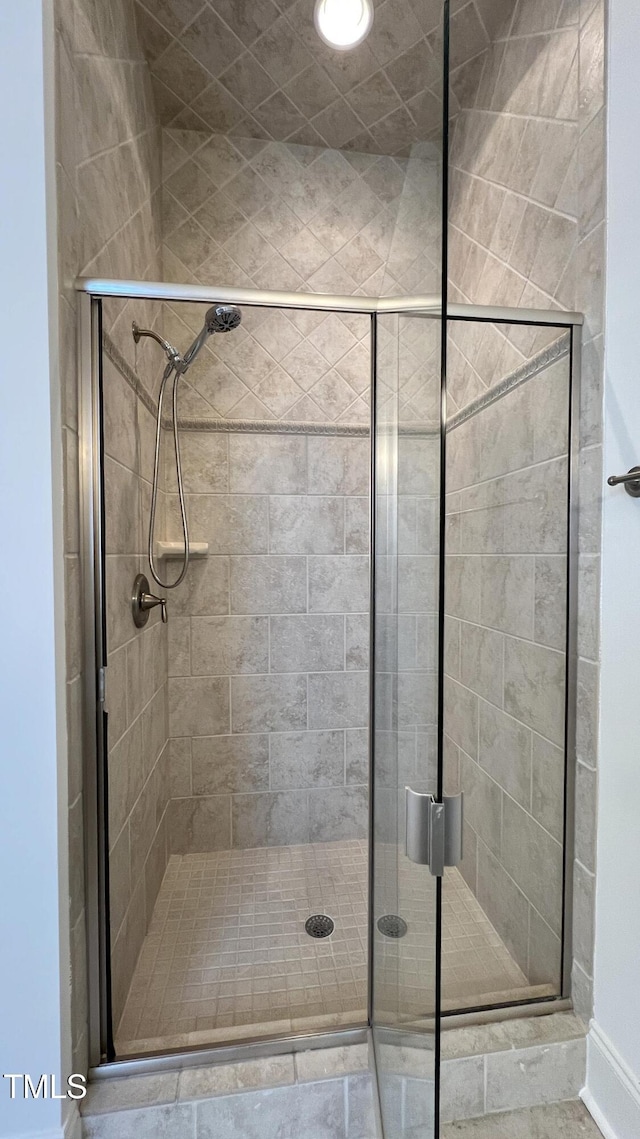 bathroom with a shower with door