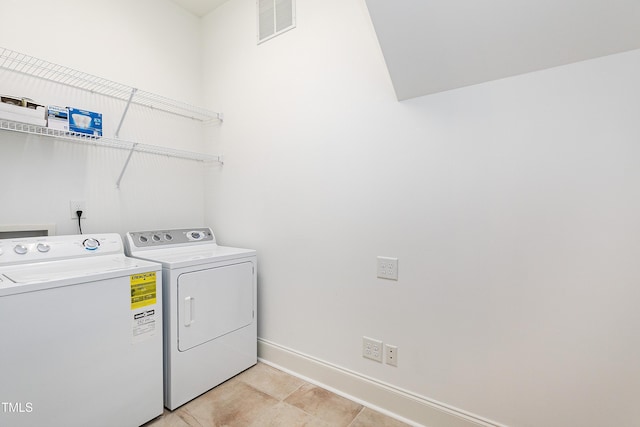 clothes washing area with washer and clothes dryer