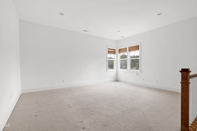 spare room with light colored carpet