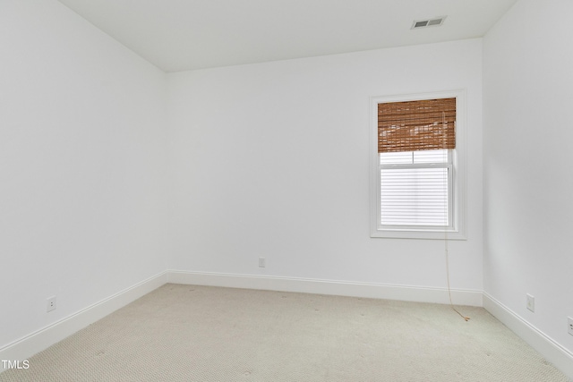 empty room featuring light carpet