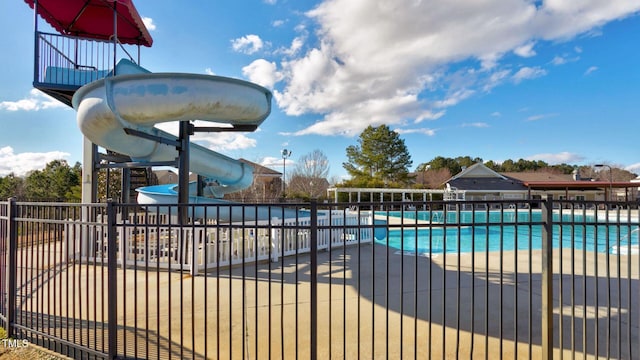 view of swimming pool with a water slide