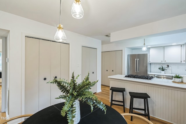 dining space with light wood-type flooring