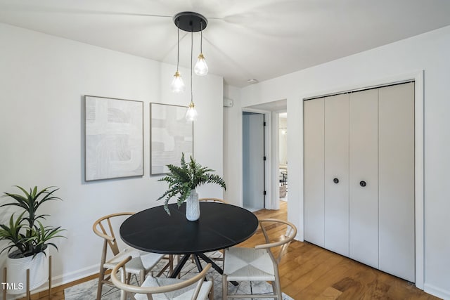 dining space with wood-type flooring