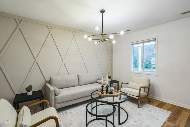 living room featuring wood-type flooring and a notable chandelier