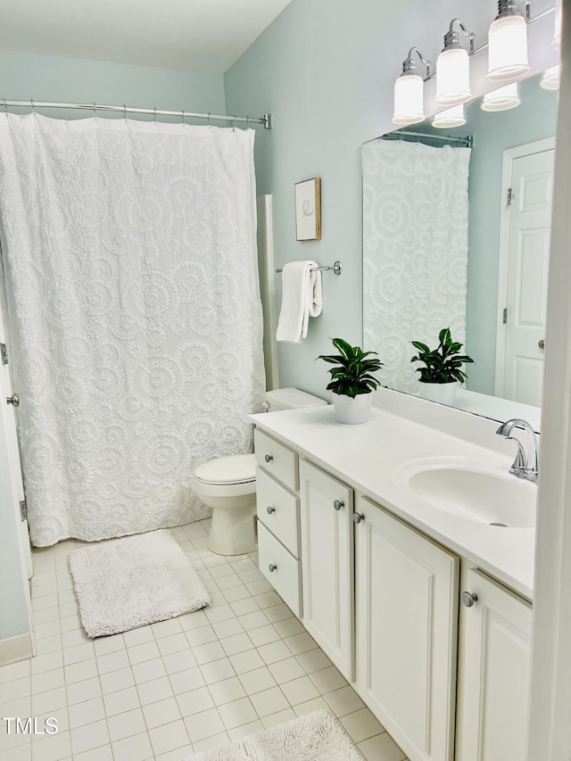 bathroom featuring toilet, vanity, and tile patterned floors