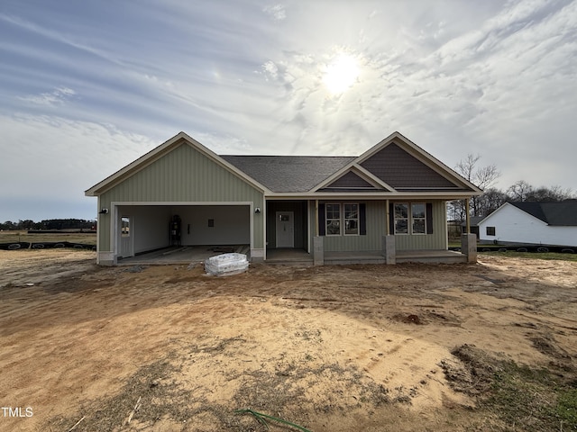 view of front of home featuring an attached garage and a porch