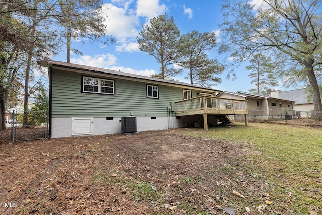 back of house with a wooden deck and central AC