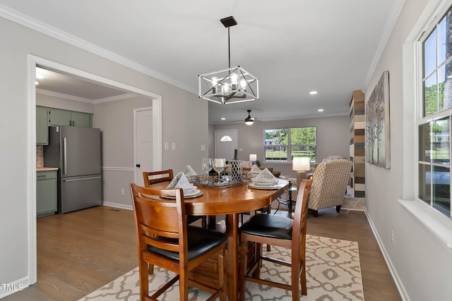 2704 Ross Rd, Durham, NC 27703 - dining area with a chandelier, dark wood finished floors, a ceiling fan, crown molding, and recessed lighting