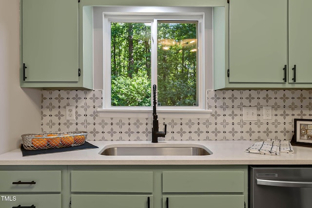 2704 Ross Rd, Durham, NC 27703 - kitchen with green cabinets, stainless steel dishwasher, a sink, light countertops, and decorative backsplash