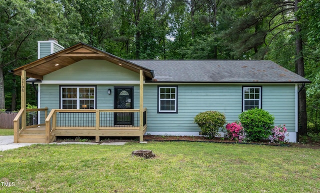 2704 Ross Rd, Durham, NC 27703 - ranch-style house with a chimney, a front lawn, a shingled roof, and a wooden deck