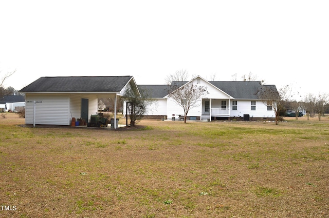 rear view of property featuring a yard