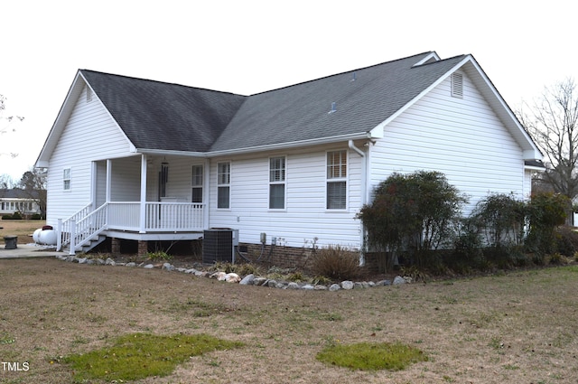 exterior space with a porch, a yard, and central AC unit