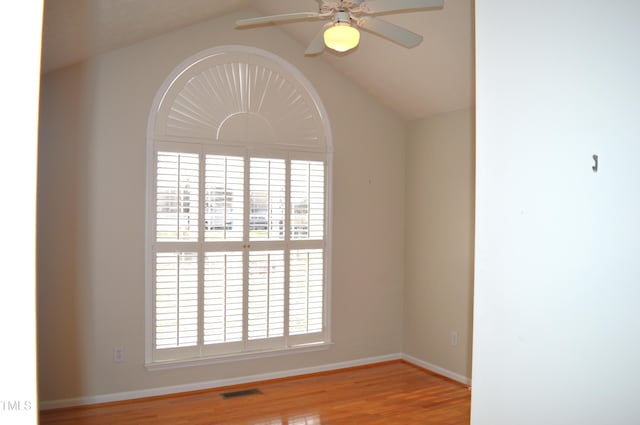 empty room featuring light wood-type flooring, ceiling fan, and lofted ceiling