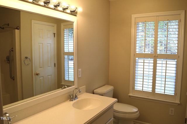 bathroom with a shower, vanity, and toilet